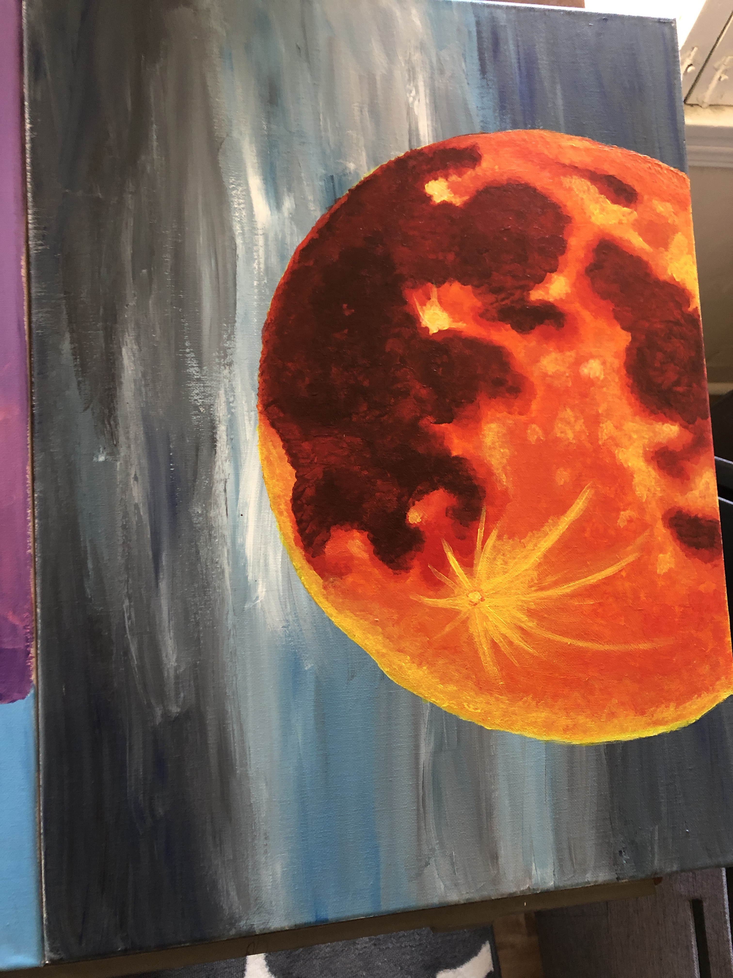 An orange colored moon against a blue background, aqcrylic painting